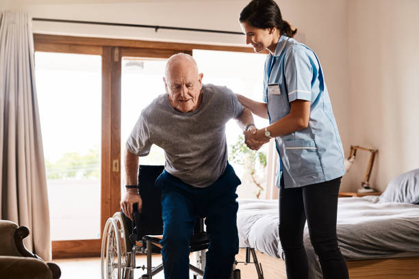 Wessex Healthcare supplies quality mobility products and independent living aids to the less abled and disabled molift active raiser patient lift - nurse helping a senior man get up from a wheelchair