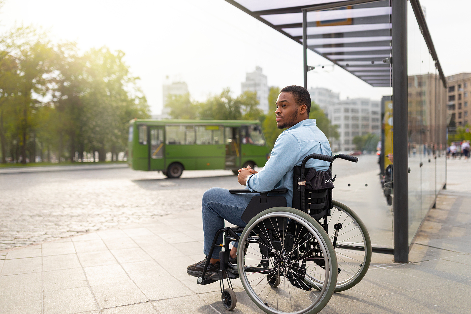 Wessex Healthcare supplies quality mobility products and independent living aids to the less abled and disabled ibis breezy wheelchair - man in wheelchair waiting for public transport